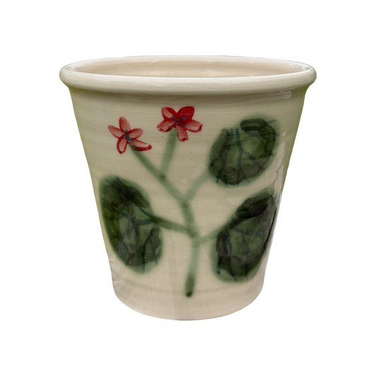 Ceramic pot with floral design on a white background