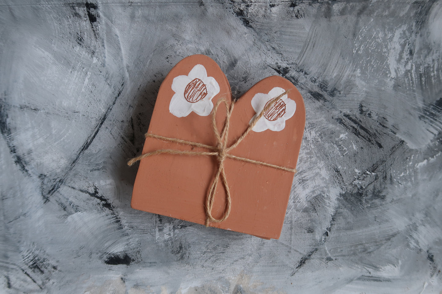 Terracotta boarder tiles for use in the garden.   Rolled out and cut by hand in terracotta clay, detailed with white slip, sgraffito daisies and stamped on the back.  Paige Mitchell. Handmade Ceramics.